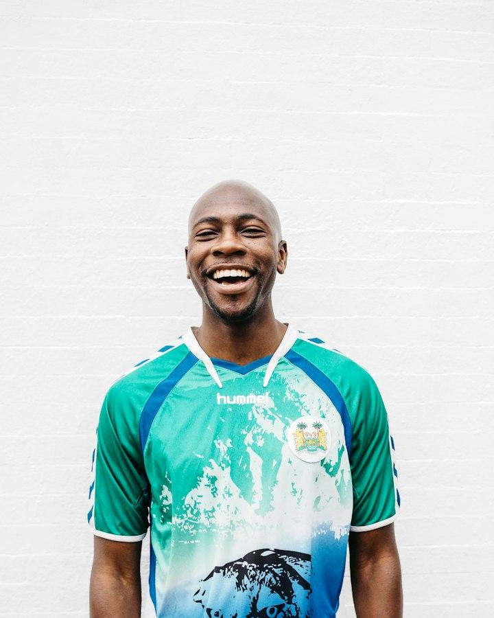 A man in a green jersey, laughing