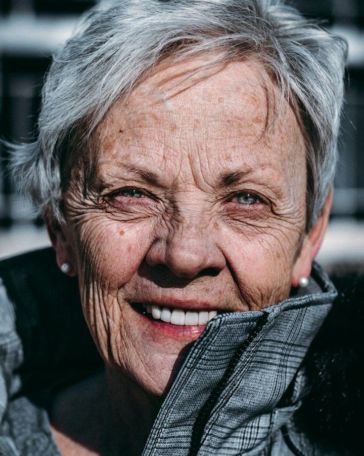 An older woman with silver hair, smiling