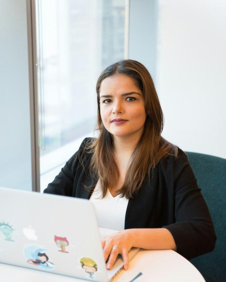 A woman at her desk with a laptop